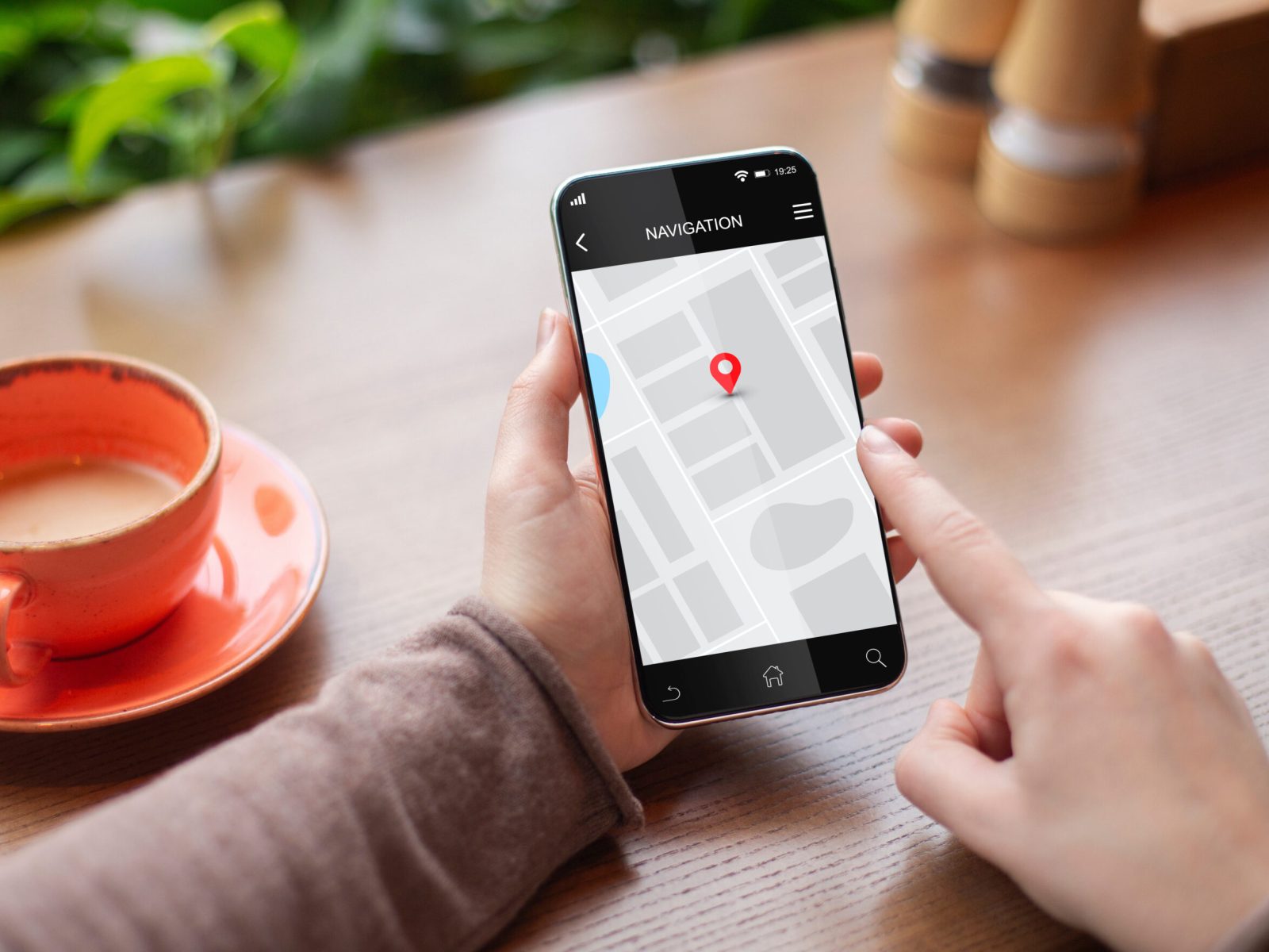 Woman Using Navigation Application On Smartphone, Closeup Of Hands Browsing Route Via Mobile Phone Sitting In Cafe Indoors. GPS Navigator App. Cropped, Selective Focus